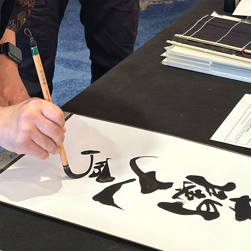 japanese calligraphy artist writing bold sumi strokes