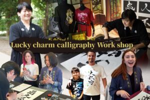 lucky charm calligraphy workshop with visitors in Japan