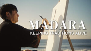 Japanese calligraphy artist Madara creating a large-scale Hisseki-jutsu artwork on the beach — documentary film poster image